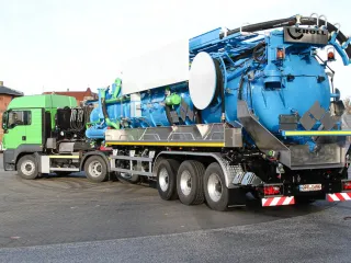 Blauer Saug-Sattelauflieger mit Separator und Saugschlauch, Schrägansicht von hinten